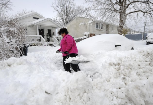 woman diggin out from a snow storm